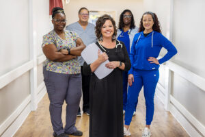 5 caregivers and nurses in the hallway at the West Village facility