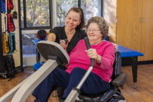 A rehab therapist with a resident in the rehab gym at the West Village facility