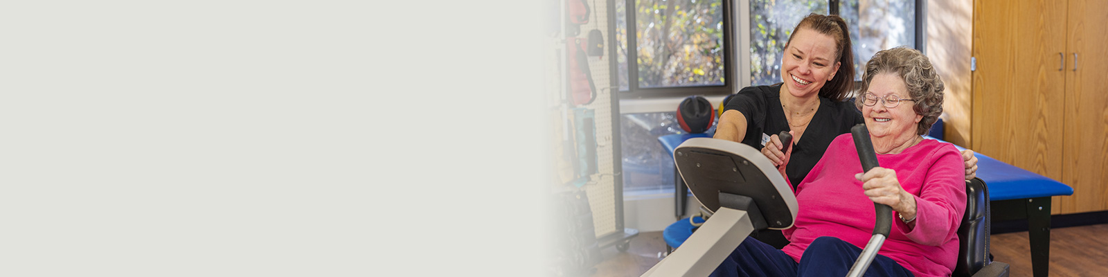 A rehab therapist with a a resident in the rehab gym at West Village Care